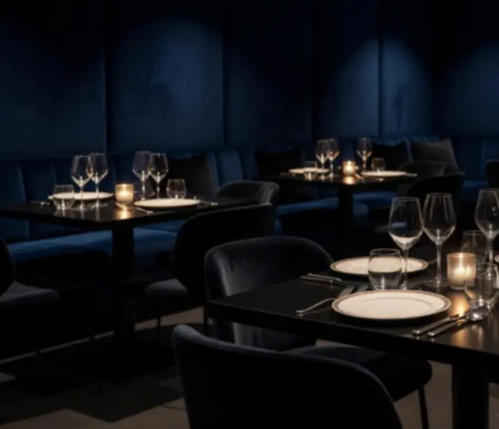 Dimly lit evening dining table set for a refined reservation at Ashandaceclub